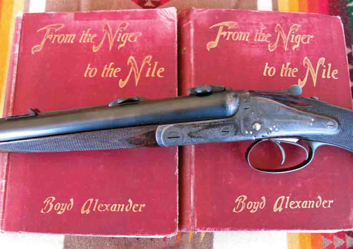 A Holland & Holland .500 Express rifle from 1889 resting on two volumes of books written by the previous owner. A third volume was never produced as the rifle’s owner was speared to death during a subsequent safari.